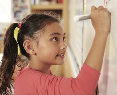 Girl writing on whiteboard