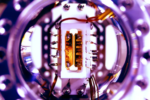 Close up view of a Quantum Processor with many cables and filaments all feeding into a central testing unit